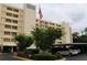 Exterior of condo building featuring an American flag and covered parking at 700 Mirror Nw Ter # 303, Winter Haven, FL 33881