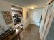 Hallway to kitchen with carpet flooring and closet space at 700 Mirror Nw Ter # 303, Winter Haven, FL 33881