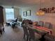 Inviting living room with comfortable seating, a glass table, and a scenic lake view at 700 Mirror Nw Ter # 303, Winter Haven, FL 33881