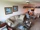 Cozy living room with a comfortable sofa, artful decor, and inviting dining area at 700 Mirror Nw Ter # 303, Winter Haven, FL 33881