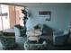 This is a lounge with comfortable seating and a leafy plant at 700 Mirror Nw Ter # 303, Winter Haven, FL 33881