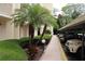 Covered parking area features lush landscaping and convenient access to the building at 700 Mirror Nw Ter # 303, Winter Haven, FL 33881