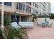 Inviting patio area with comfortable seating and beautiful landscaping, perfect for relaxing outdoors at 700 Mirror Nw Ter # 303, Winter Haven, FL 33881