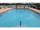 Refreshing community pool with clear water, perfect for swimming laps or lounging in the sun at 700 Mirror Nw Ter # 303, Winter Haven, FL 33881
