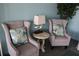 Comfortable sitting area with patterned pillows, modern lamp, and decorative bird statues at 700 Mirror Nw Ter # 303, Winter Haven, FL 33881