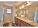 Bathroom boasts double sinks, granite countertops, a large mirror, and updated fixtures at 710 Persian Dr, Haines City, FL 33844