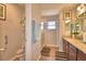 Well-lit bathroom featuring a granite countertop, modern fixtures, and a shower with a glass door at 710 Persian Dr, Haines City, FL 33844