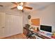 Bedroom featuring wood floors, a desk, a cork board, and double bi-fold doors at 710 Persian Dr, Haines City, FL 33844