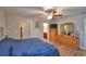 Bright bedroom with a ceiling fan and wood floors, plus large dresser with a mirror at 710 Persian Dr, Haines City, FL 33844
