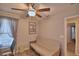 The home's bedroom provides a futon and desk area, complemented by a modern ceiling fan at 710 Persian Dr, Haines City, FL 33844