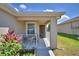 Cozy front porch features outdoor seating, a small garden and a walkway leading to the front door at 710 Persian Dr, Haines City, FL 33844