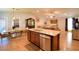 Open floor plan kitchen with granite countertops, stainless steel appliances, and an island with a sink at 710 Persian Dr, Haines City, FL 33844