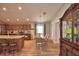 Open-concept kitchen and dining area with stainless steel appliances and a large island at 710 Persian Dr, Haines City, FL 33844