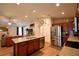 Kitchen with stainless steel appliances, tile backsplash, granite counters, and an island with a sink at 710 Persian Dr, Haines City, FL 33844