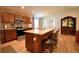 Kitchen island with seating, stainless appliances, and modern countertops at 710 Persian Dr, Haines City, FL 33844
