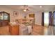 Open living room features wood floors, furniture, a ceiling fan and an open concept layout at 710 Persian Dr, Haines City, FL 33844