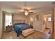 Serene bedroom featuring neutral tones, a ceiling fan, and an ensuite bathroom at 710 Persian Dr, Haines City, FL 33844
