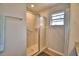 Shower featuring glass doors, a window, and tile flooring at 710 Persian Dr, Haines City, FL 33844