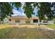 View of the home's backyard, featuring a fenced lawn with shaded trees and natural light at 780 Oleander Se Dr, Winter Haven, FL 33880