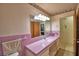 Pink-tiled bathroom featuring retro accents, a long vanity, and a bathtub with a shower curtain at 780 Oleander Se Dr, Winter Haven, FL 33880