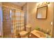 Cozy bathroom featuring a walk-in shower and a pedestal sink with a large square mirror at 780 Oleander Se Dr, Winter Haven, FL 33880