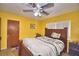 Bright bedroom with a ceiling fan and a traditional wooden bed frame with a striped white comforter at 780 Oleander Se Dr, Winter Haven, FL 33880