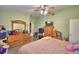Spacious bedroom with green walls, ceiling fan and a large dresser plus wardrobe for ample storage solutions at 780 Oleander Se Dr, Winter Haven, FL 33880