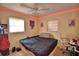 Cozy bedroom with LED strip lighting, a ceiling fan, and a comfortable bed plus a study area at 780 Oleander Se Dr, Winter Haven, FL 33880