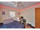 Cozy bedroom with LED strip lighting, a ceiling fan, and a comfortable bed plus a study area at 780 Oleander Se Dr, Winter Haven, FL 33880