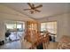 Sunlit dining room with tile floors, wood table and chairs, and sliding glass doors leading to a screened porch at 780 Oleander Se Dr, Winter Haven, FL 33880