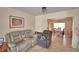 Inviting living room area with tile flooring and view into the dining room at 780 Oleander Se Dr, Winter Haven, FL 33880
