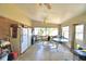 A sunroom area with white appliances and furniture; has lots of windows at 780 Oleander Se Dr, Winter Haven, FL 33880
