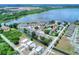 Aerial view featuring a community with a swimming pool near a long lake and canals at 900 Avenue Z Se # B2, Winter Haven, FL 33880
