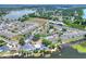 An aerial view shows the property, adjacent to a lake, with a community pool at 900 Avenue Z Se # B2, Winter Haven, FL 33880
