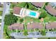 Aerial view showcasing the community pool surrounded by buildings and parking areas at 900 Avenue Z Se # B2, Winter Haven, FL 33880