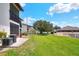 A large grass backyard with patio areas and views of other buildings in the community at 900 Avenue Z Se # B2, Winter Haven, FL 33880