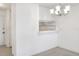 Bright dining area with white walls, tile flooring, and chandelier lighting at 900 Avenue Z Se # B2, Winter Haven, FL 33880