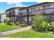 Well-maintained building exterior featuring lush landscaping, an exterior staircase, and multiple units at 900 Avenue Z Se # B2, Winter Haven, FL 33880