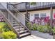 Exterior staircase leading to upper units with a view of the lower-level entrance and lush landscaping at 900 Avenue Z Se # B2, Winter Haven, FL 33880