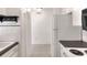 Clean kitchen with white appliances, tile backsplash, and seamless passthrough window at 900 Avenue Z Se # B2, Winter Haven, FL 33880