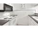 Well-lit kitchen features a stove, tile backsplash, and dark countertops at 900 Avenue Z Se # B2, Winter Haven, FL 33880