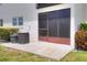 Private outdoor patio with access to air conditioning units and a doorway at 900 Avenue Z Se # B2, Winter Haven, FL 33880