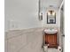 Bathroom featuring a wood vanity with a sink, mirror, tile walls, and lighting fixtures at 900 Lake Jessie Dr, Winter Haven, FL 33881