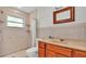 Bright bathroom with a shower, sink, and window letting in natural light at 900 Lake Jessie Dr, Winter Haven, FL 33881