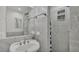 Modern bathroom featuring tiled walls, a stylish sink, and a glass-enclosed shower at 900 Lake Jessie Dr, Winter Haven, FL 33881