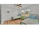 Bright bedroom with hardwood floors, ceiling fan, and large window for ample natural light at 900 Lake Jessie Dr, Winter Haven, FL 33881