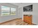Bedroom with a large window, a view of the lake, and a wall-mounted TV at 900 Lake Jessie Dr, Winter Haven, FL 33881