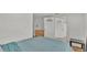 Bedroom featuring a blue patterned blanket, light walls, and white trim at 900 Lake Jessie Dr, Winter Haven, FL 33881