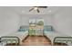 Bright bedroom with hardwood floors, ceiling fan, and large window for ample natural light at 900 Lake Jessie Dr, Winter Haven, FL 33881