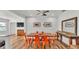 Bright dining room with wood floors, modern lighting, and a view through a doorway to outside at 900 Lake Jessie Dr, Winter Haven, FL 33881